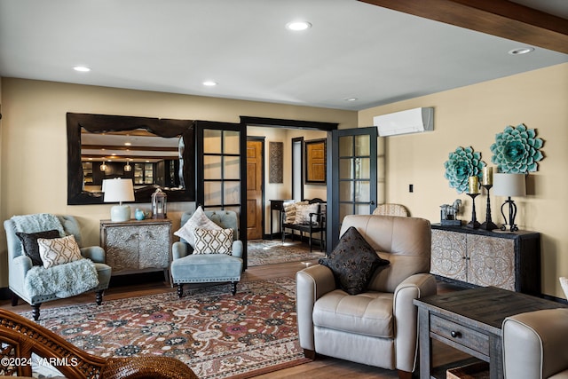 living area featuring recessed lighting, an AC wall unit, and wood finished floors