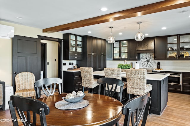 dining space with a wall unit AC, light wood-type flooring, beamed ceiling, and recessed lighting