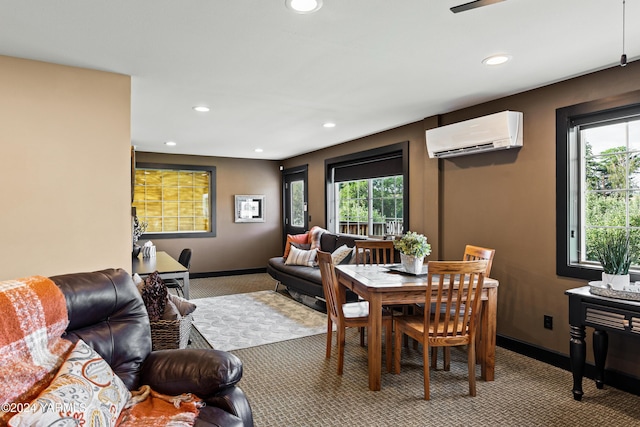 dining area featuring light colored carpet, a wall unit AC, baseboards, and recessed lighting