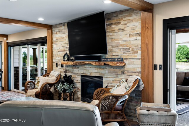 living room featuring a fireplace and beam ceiling