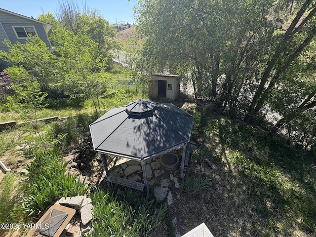 view of yard with a storage shed and an outbuilding
