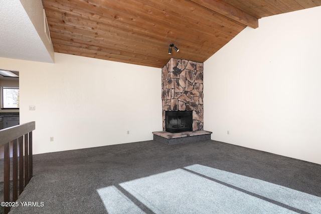 unfurnished living room featuring lofted ceiling with beams, a fireplace, carpet flooring, and wooden ceiling