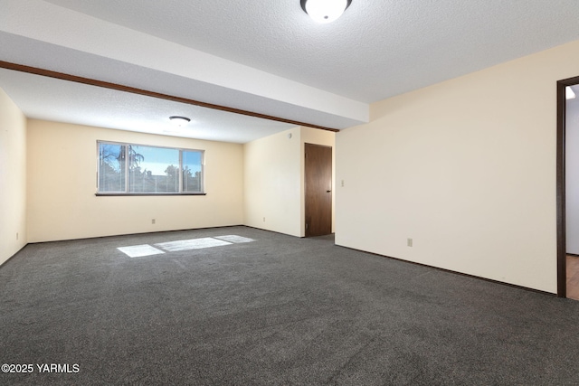 unfurnished room with carpet flooring and a textured ceiling