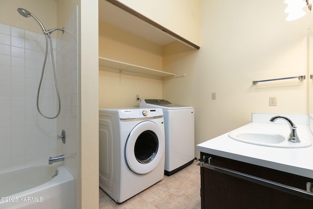 clothes washing area with laundry area, a sink, and independent washer and dryer