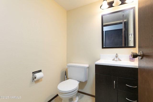 half bathroom with tile patterned flooring, vanity, toilet, and baseboards