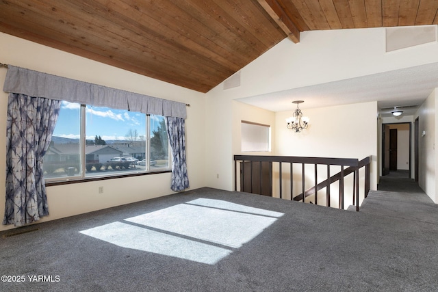 empty room with a chandelier, wood ceiling, carpet flooring, and vaulted ceiling with beams