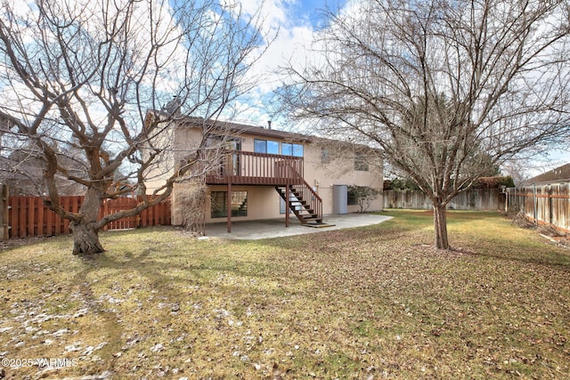 back of property with a fenced backyard, stairs, a yard, stucco siding, and a patio area