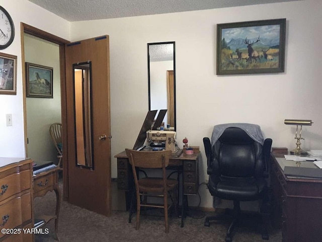 office area with a textured ceiling and dark carpet