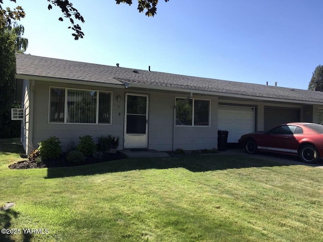 single story home with a garage, a shingled roof, and a front lawn