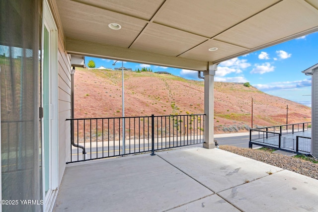 view of patio / terrace featuring a mountain view and a balcony