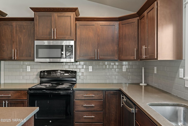 kitchen with stainless steel appliances, lofted ceiling, decorative backsplash, and light countertops