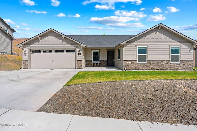 view of front facade featuring stone siding, an attached garage, and driveway