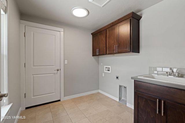 washroom featuring hookup for an electric dryer, hookup for a washing machine, cabinet space, and baseboards