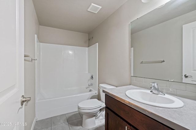 full bath with toilet, tasteful backsplash, vanity, tile patterned flooring, and shower / bathtub combination