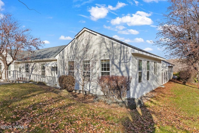 view of home's exterior with a yard