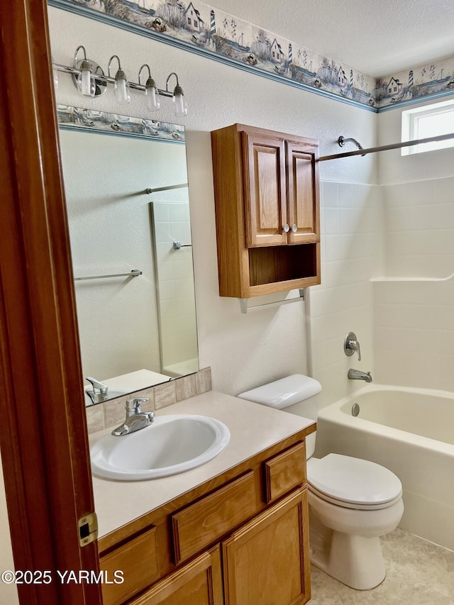 full bath featuring a textured ceiling, shower / bathing tub combination, vanity, and toilet