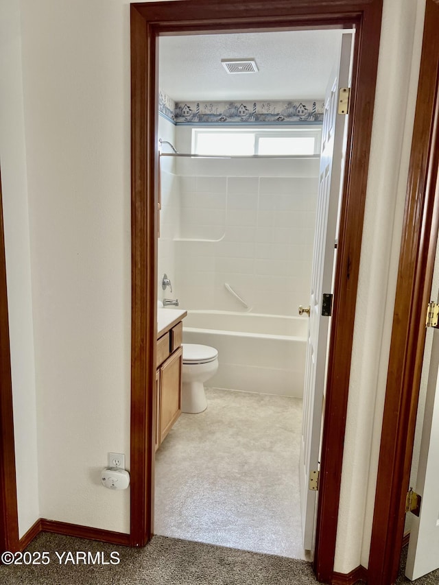 full bath featuring toilet, vanity, visible vents, baseboards, and washtub / shower combination