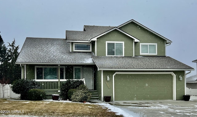 view of front of property with a shingled roof, concrete driveway, and an attached garage