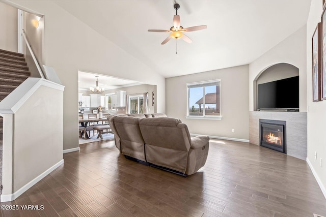 1589 Valhalla Loop, Selah, WA 98942 - living room with a tile fireplace, vaulted ceiling, ceiling fan, wood finished floors, and a chandelier