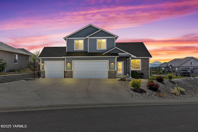 1589 Valhalla Loop, Selah, WA 98942 - view of front of house featuring stone siding, driveway, a garage, and an attached garage