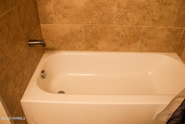 bathroom with a tub to relax in