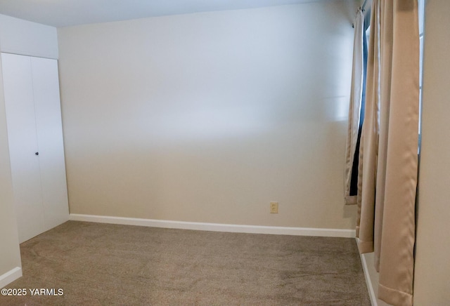 unfurnished bedroom featuring a closet, baseboards, and carpet flooring