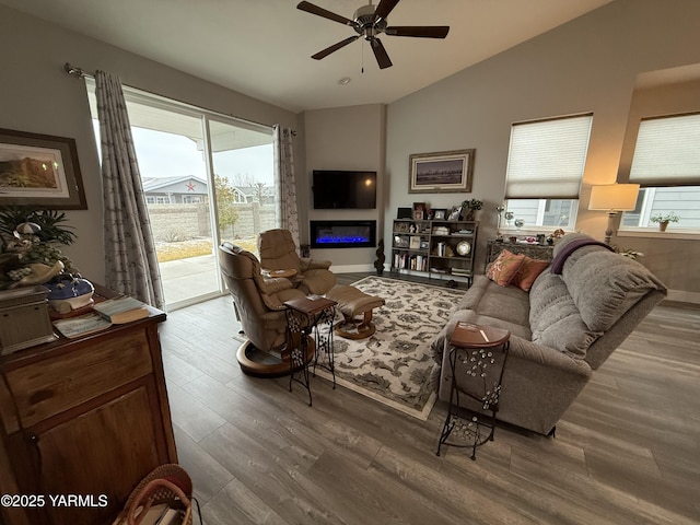 living room featuring vaulted ceiling, plenty of natural light, and wood finished floors