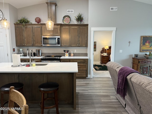 kitchen with visible vents, appliances with stainless steel finishes, pendant lighting, and light countertops