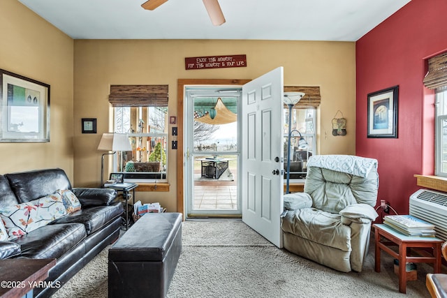 carpeted living area with a healthy amount of sunlight and a ceiling fan