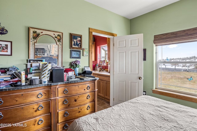 tiled bedroom featuring a sink