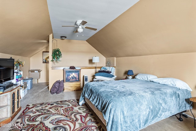 bedroom with vaulted ceiling, carpet, and ceiling fan