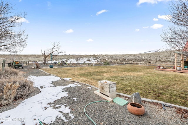 view of yard featuring a mountain view and fence