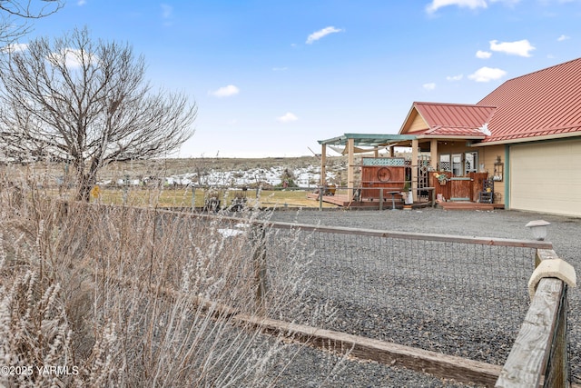 view of yard featuring an attached garage and fence