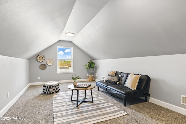 living area featuring carpet floors, baseboards, and vaulted ceiling