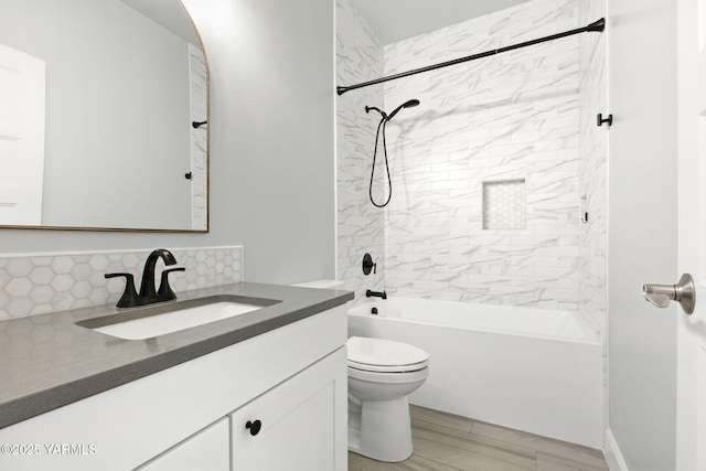 full bathroom featuring backsplash, toilet, washtub / shower combination, and vanity