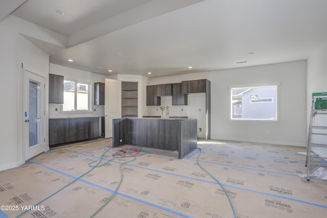 kitchen with recessed lighting, baseboards, dark brown cabinets, and a center island