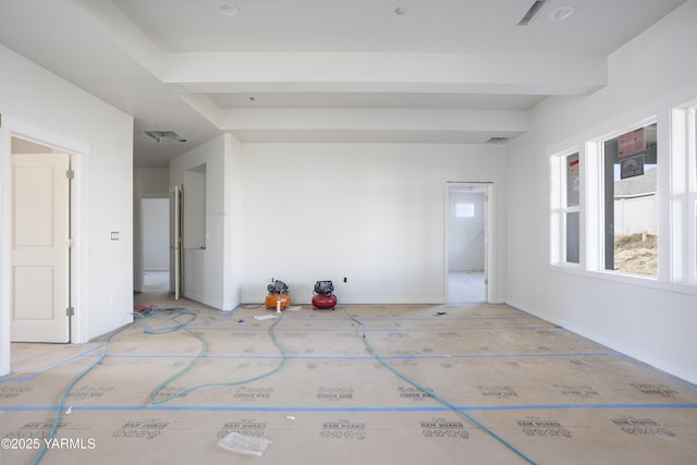 unfurnished room with baseboards and beamed ceiling