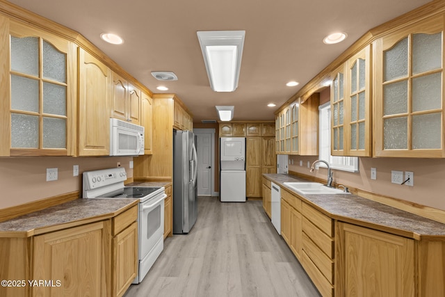 5804 W Walnut St, Yakima, WA 98908 - kitchen featuring white appliances, estacked washer and dryer, light wood-type flooring, glass insert cabinets, and recessed lighting