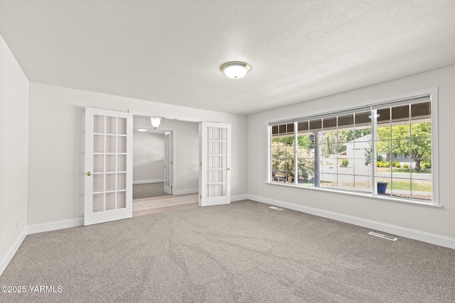 5804 W Walnut St, Yakima, WA 98908 - unfurnished room featuring french doors, carpet, and a textured ceiling