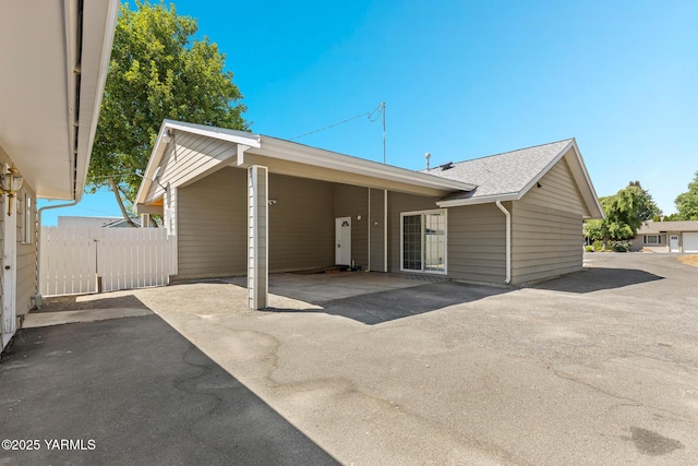 5804 W Walnut St, Yakima, WA 98908 - back of property with asphalt driveway and an attached carport