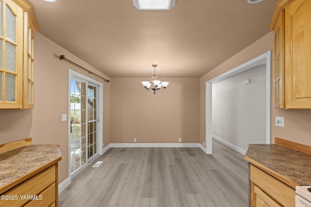 5804 W Walnut St, Yakima, WA 98908 - unfurnished dining area featuring light wood-type flooring and a chandelier