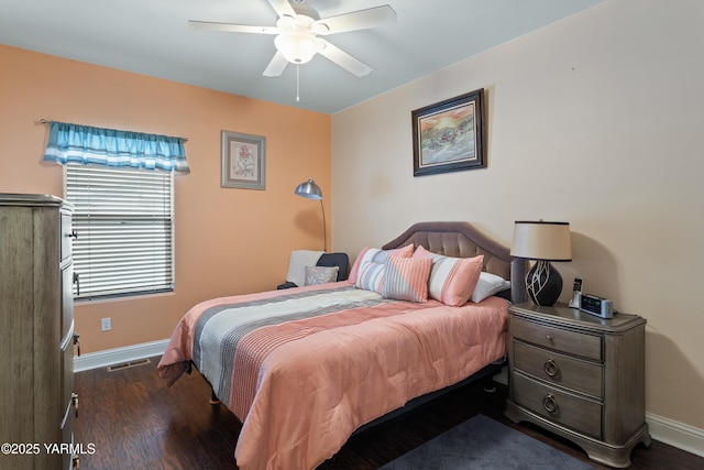 bedroom with visible vents, baseboards, ceiling fan, and dark wood-type flooring