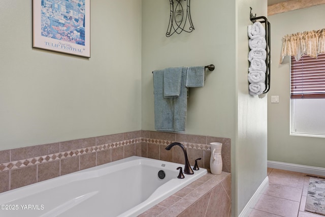 bathroom featuring tile patterned flooring, a bath, and baseboards