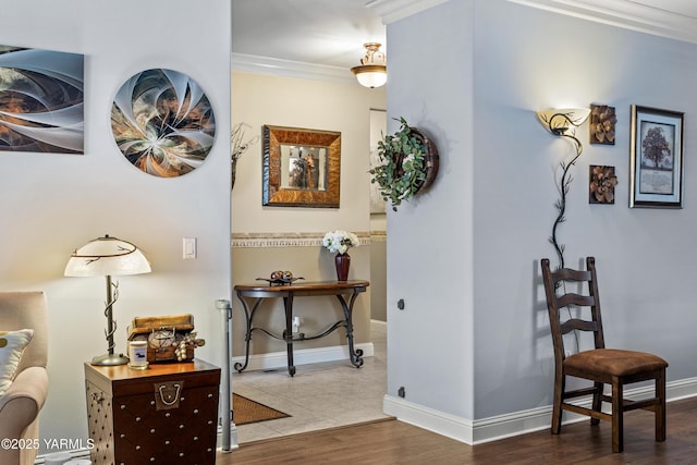 hallway with baseboards, wood finished floors, and crown molding