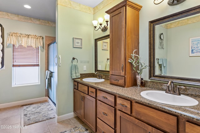 bathroom featuring double vanity, a shower stall, and a sink