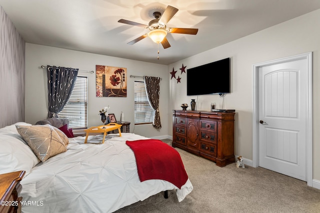 bedroom with ceiling fan, baseboards, and light colored carpet