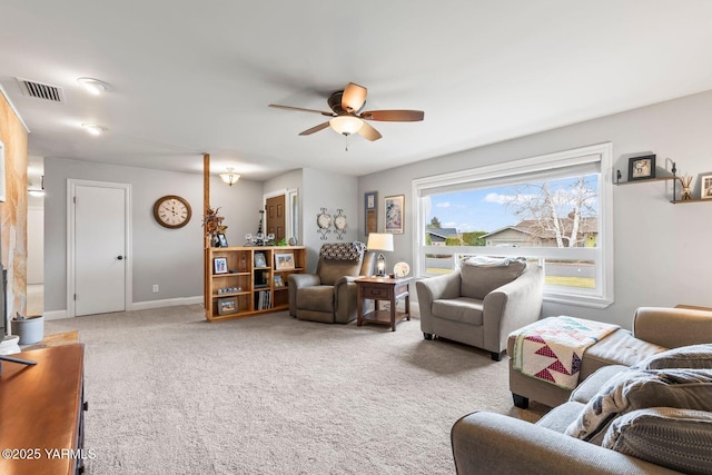 carpeted living room with baseboards, visible vents, and ceiling fan