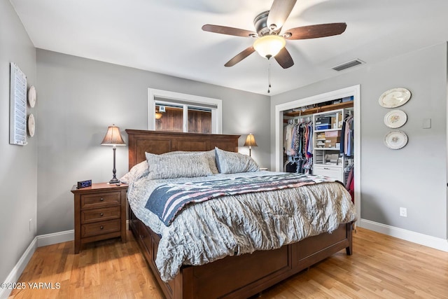 bedroom with light wood finished floors, visible vents, a closet, and baseboards