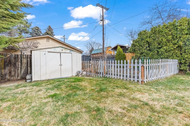 view of yard featuring an outbuilding, a storage shed, and fence