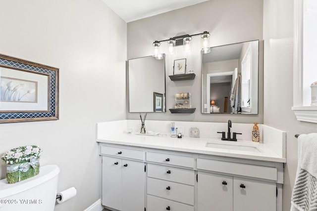 bathroom featuring toilet and vanity